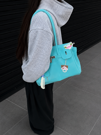 Jelly Firkin Sky blue shoulder bag with charms in a casual streetwear look