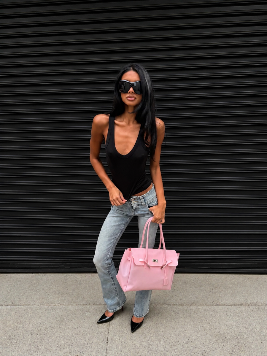 Model holding the Jelly Firkin Blush pink bag with a streetwear outfit